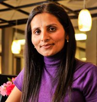 Payal Soni-Patel, PA-C Physician Assistant Smilling In a Purple Turtleneck