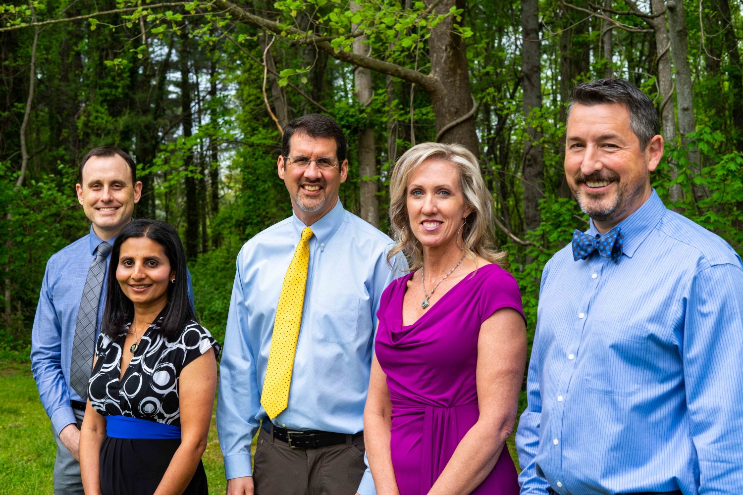 Asheville Neurology Specialists Team Standing In The Woods Smiling